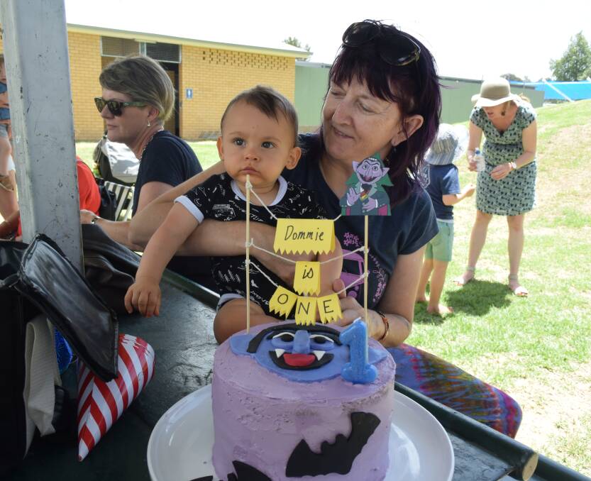 Dommie and Michelle Rohan ready to blow out the candle on his first birthday cake.  