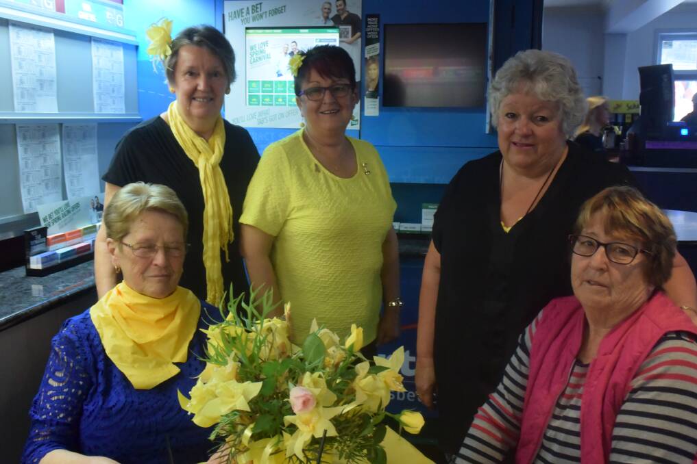 Members of the community enjoying the 2016 'Yellow Day' Can-Assist fundraiser at the Criterion Hotel.