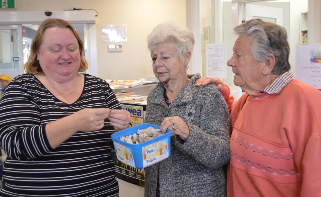 Grenfell Librarian Erica Kearnes helps draw the FOGL Father's Day raffle with Margaret Whitty and Elaine Keys.  