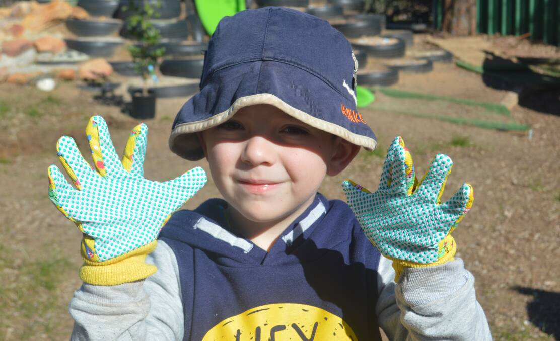 Little Mason Smith is ready to plant during a visit from Bunnings Cowra staff at Grenfell Preschool last Friday July 27. 