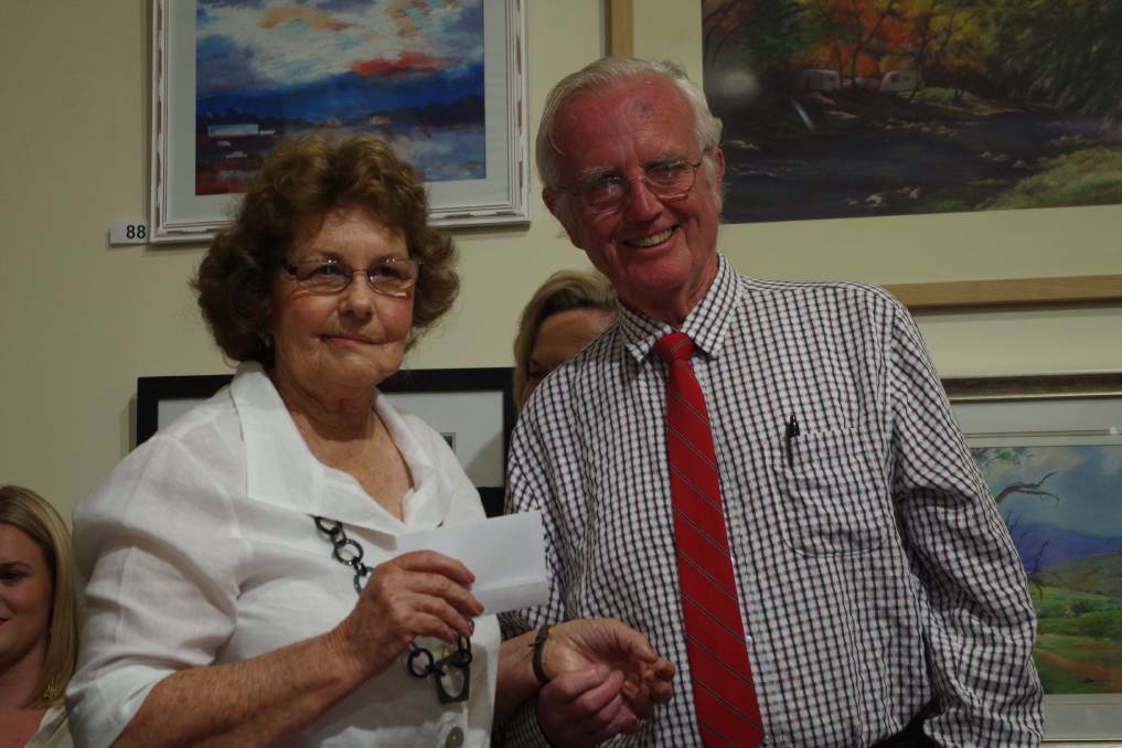 Winner of the G.O. Kruger Memorial Prize for the most outstanding painting in the exhibition was Grenfell's Beverly Lappan, receiving her prize from Jim Wright.