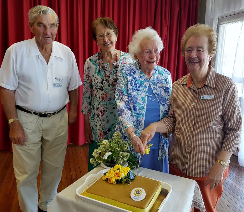 President L Schaeffer, C Mitton, oldest member K Smith and newest member G Reynolds cut the cake.  