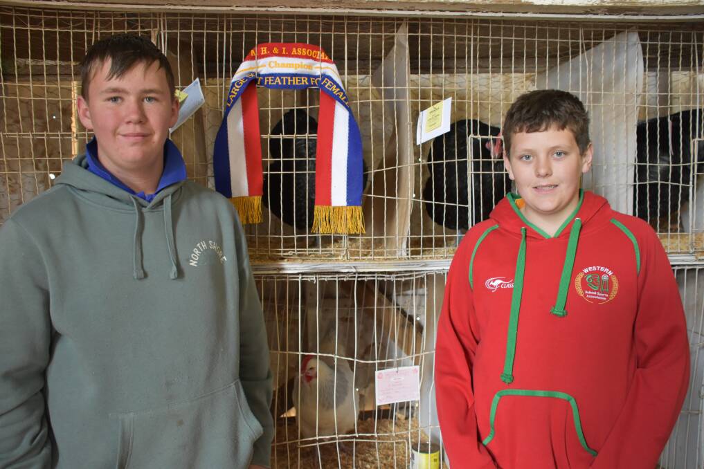 Bailey and Riley Edwards with their winning Largest Feathered Foul Female Champion ribbon. 