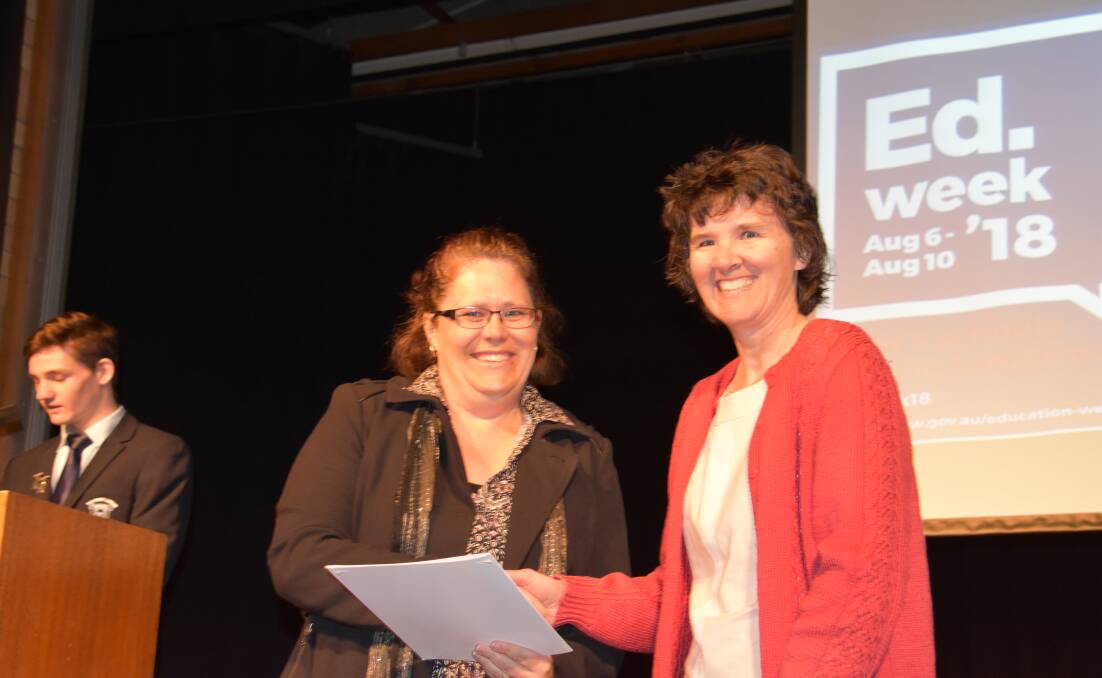 THLHS teacher Tracey Cartwright receives and award from P&C president Beth Knight. 