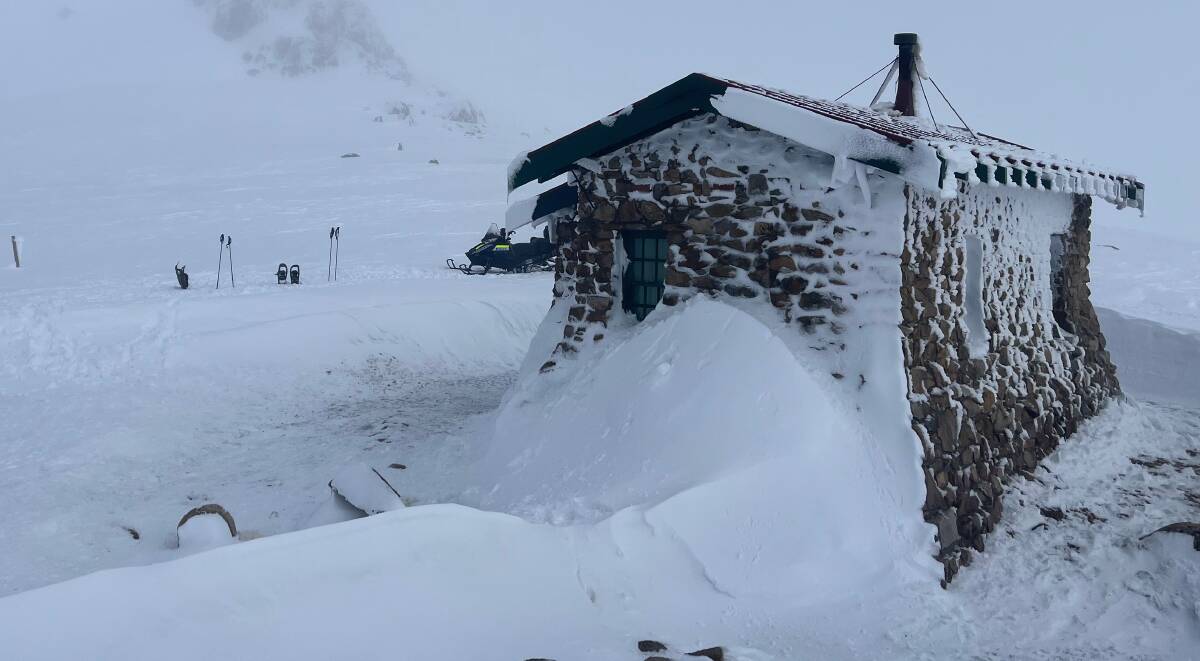 The heavy snow piled up against the hut, which again provided a vital safe haven for four hikers caught out by the alpine weather conditions. Picture: NSW Police 