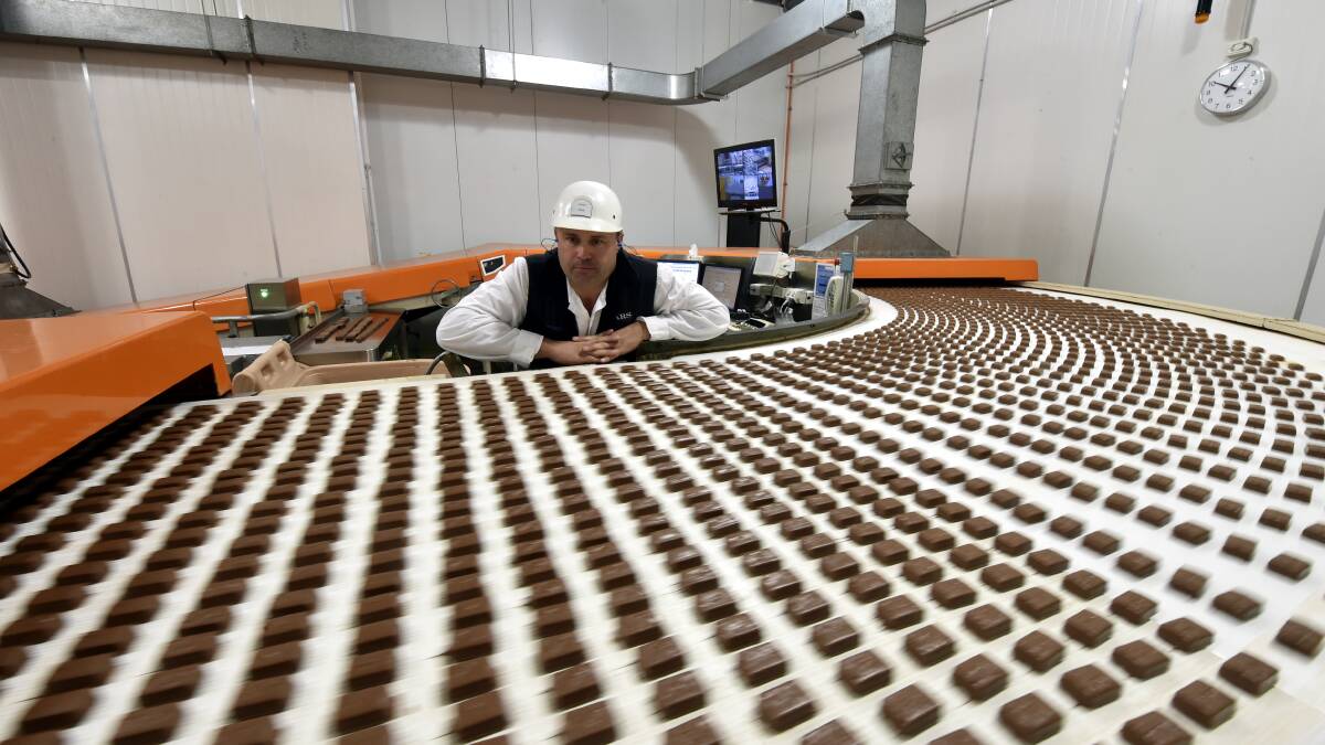 Chocolate factory dream: A worker inspecting chocolates for Mars, which has topped a list for best places to work in the category for organisations with 1000 employees or more. 