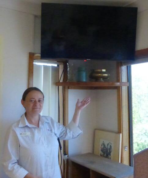 Nurse Manager Jackie Skinner with the newly wall mounted televisions purchased last year by the Auxiliary. Image supplied.