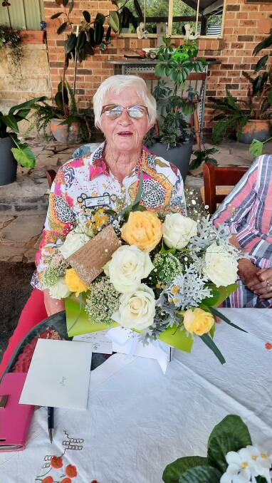 Jenny Wells' service to the club over many years was honoured with a gift and bouquet of flowers. Image supplied.