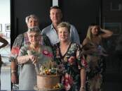 Glenice Clarke cutting her 80th birthday Cake surrounded by her children Megan,  Andrew and Kerrie. (Cont).