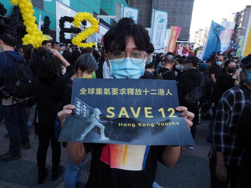 Protesters have marched in Taipei calling for China to release a dozen Hong Kong activists.