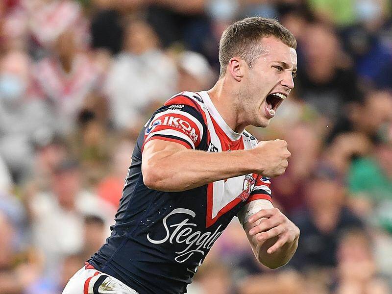 Sam Walker celebrates scoring the winning field goal as the Roosters edged the Titans in the NRL.