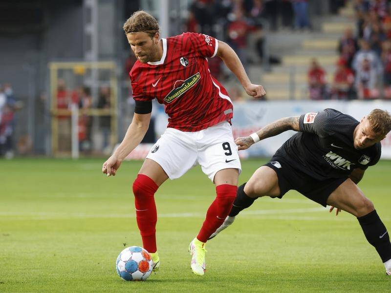 Freiburg's Lucas Holer (L) in action during his side's final match at their beloved Dreisamstadion.