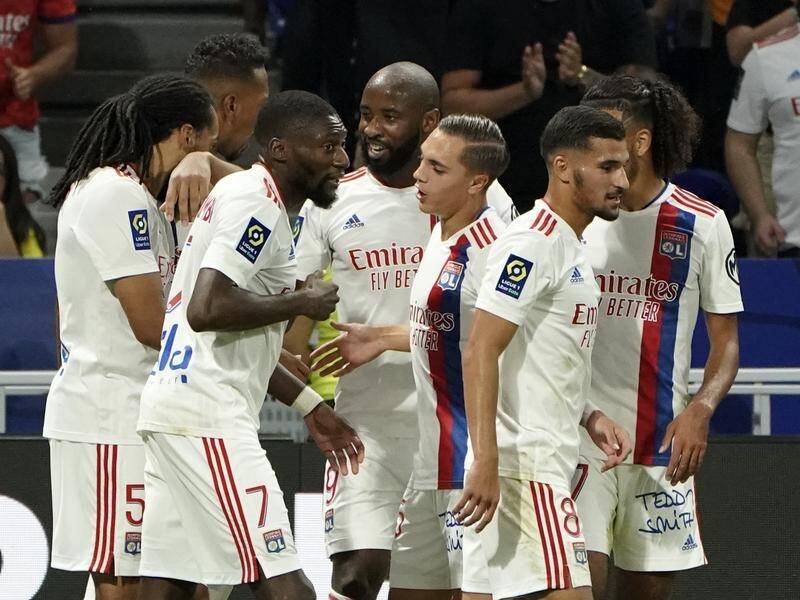 Lyon's players celebrate their second goal in their Ligue 1 win over Strasbourg.