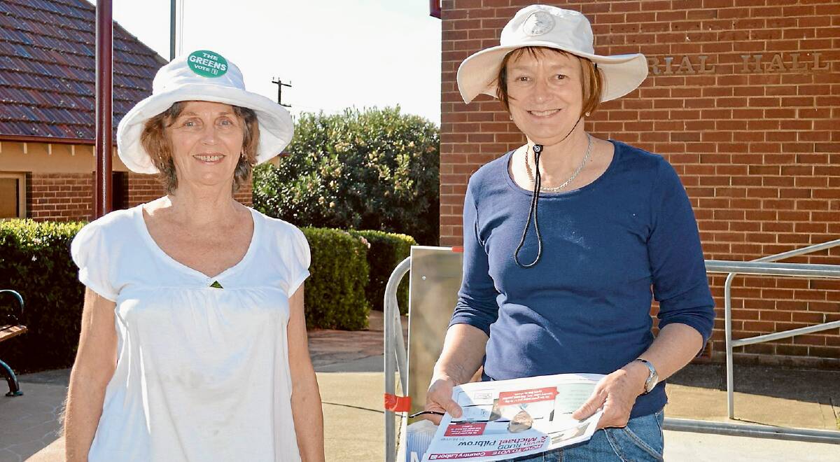 Greens Party supporter Sonia Groen and Labor’s Margaret Watt handing out leaflets on the day outside the Grenfell polling booth.