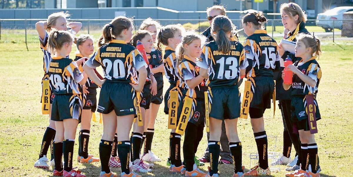 The Grenfell Junior League Tag under 12’s side having a conference with coaches Deanna Madgwick and Isabel Holmes at half time in the their match against Trundle last Saturday morning at Lawson Park.